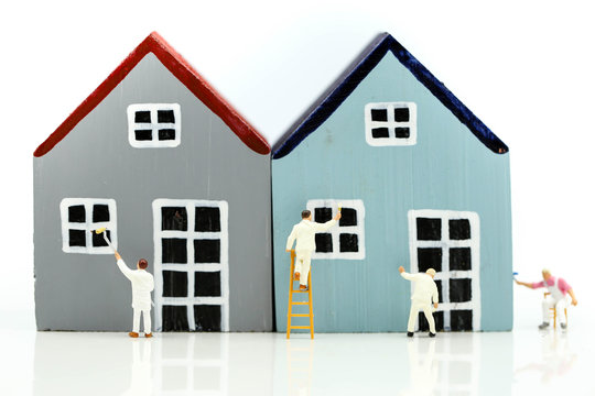 Miniature people : Workers painting a  Mini house, art, money, finance, business concept.