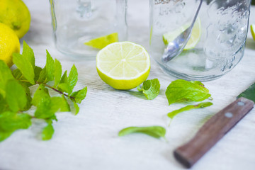 lemon, lime and mint - juicy ripe citrus on an old wooden table