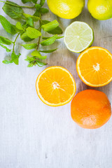 Fototapeta na wymiar orange, lemon, lime and mint - juicy ripe citrus on an old wooden table