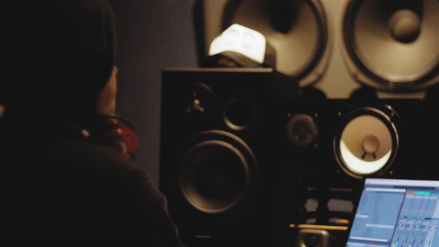 Slow Motion of Music Producer listening to a track and enjoying music