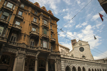 Fototapeta na wymiar View at shopping street and cathedral Santo Stefano in the center of Genoa city