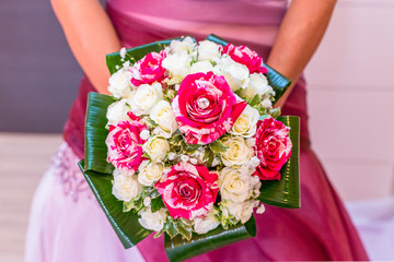 Bride with bouquet of pink roses