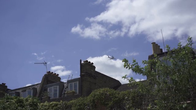 Plane flies in the sky above house