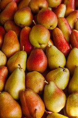 Background of freshly harvested ripe organic pears on sale at a farmers 