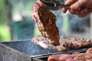 Cooking meat on a grill. Delicious fresh meat on a barbeque