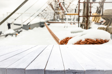 desk of free space and winter ship background. 