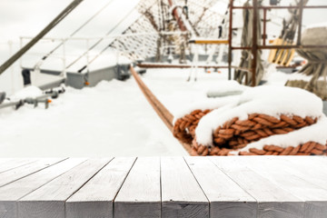 Naklejka premium desk of free space and winter ship background. 