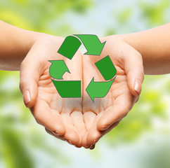people, ecology, environment and conservation concept - close up of hands holding green recycling...