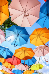 Fototapeta na wymiar Colorful Hanging Umbrellas Under a Beautiful Weather - Summer Time
