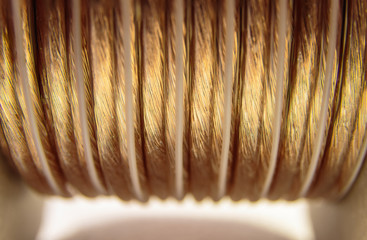Selective focus, closeup of golden coiled speaker wire