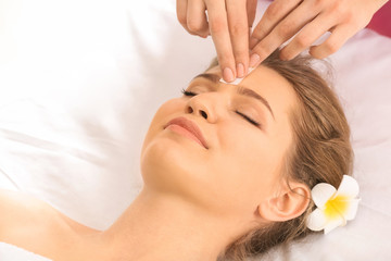 Woman having hair removal procedure on face with wax in salon