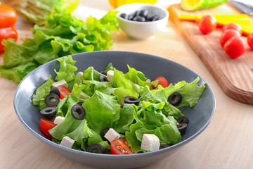 Bowl with fresh salad on table. Diet food