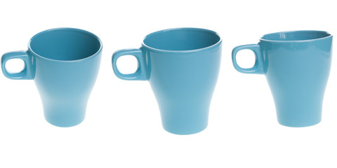 Blue cup with white inside on white wooden table. Tea time accesory