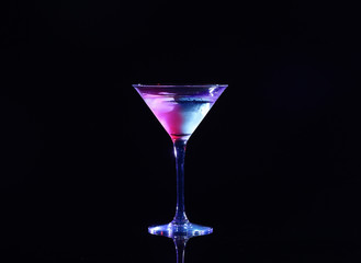 Glass with cocktail on black background