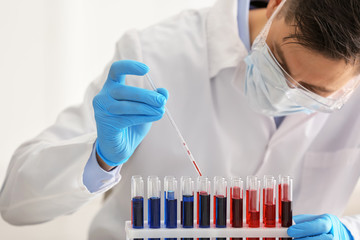 Scientist working with test tubes in laboratory