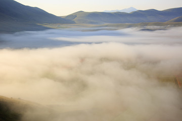 Flying on Castelluccio di Norcia, between ruins and bloom of flowers 