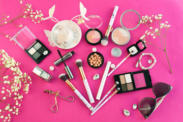 Fototapeta na wymiar Set of decorative cosmetics with makeup brushes and accessories on color background