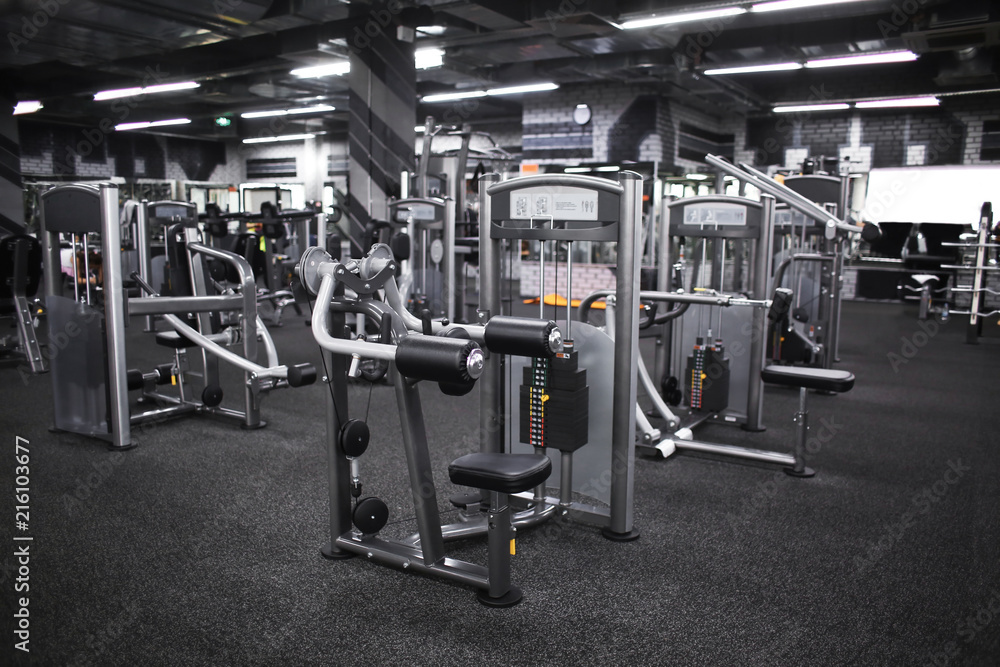 Wall mural modern equipment in new gym indoors