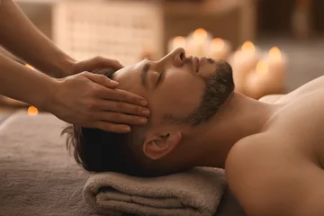Rolgordijnen Young man receiving massage at spa salon © Pixel-Shot
