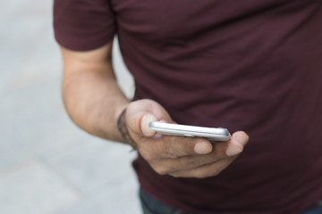 closeup of hand with mobile phone in the open air street