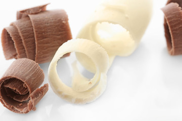 Delicious chocolate curls on white background