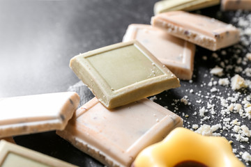 Pieces of chocolate on table, closeup