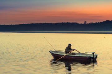 man fishes in the lakes of the Mazury