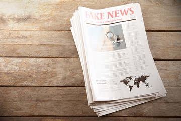Pile of newspapers on wooden background