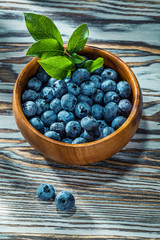 Sweet huckleberries in wooden bowl