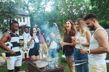 Group of friends making barbecue in the backyard. concept about good and positive mood with friends