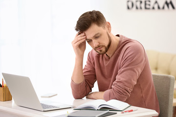 Freelancer working with laptop at home