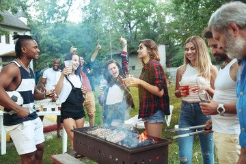 Group of friends making barbecue in the backyard. concept about good and positive mood with friends
