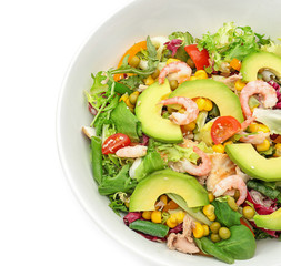 Bowl of tasty salad with ripe avocado on white background