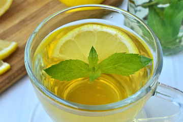 Herbal tea with lemon in a glass cup closeup.