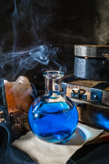 Magic concept. Blue potion in glass bottle