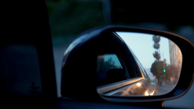 Close up shot of right side rear view mirror while car is driving.