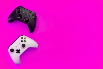 Black and white joystick xbox one s gamepad, game console on pink colourful trendy modern fashion pin-up background. Computer gaming competition videogame control confrontation concept © Юлия Завалишина