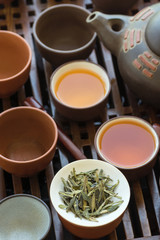 Tea set ceramic cups pot utensils on wooden bamboo dripping tray. Chinese Japanese ceremony. Freshly brewed beverage. Lifestyle. Wellness balance. Poster banner with copy space top view