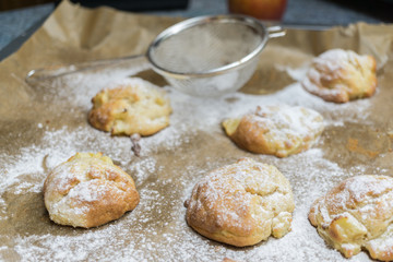 Fototapeta na wymiar Homemade little apple cakes on baking tray