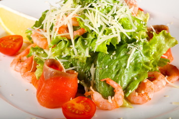 Caesar salad with shrimps and salmon