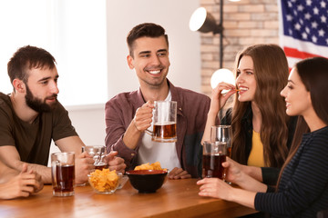 Friends drinking beer in bar