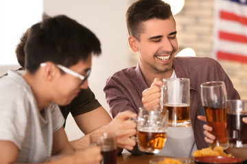 Friends drinking beer in bar