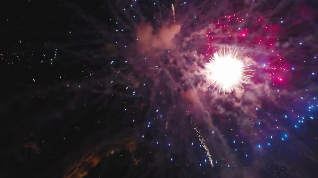 Salute close up. Quadcopter flies high above the ground amidst fireworks, between sparks, at an altitude of 200 meters