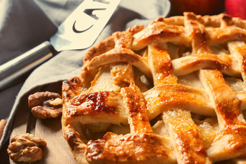Tasty homemade apple pie on wooden board