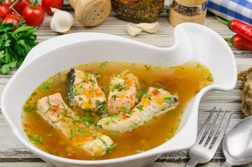 Fish soup. Fish soup with salmon on rustic wooden background. Healthy food 