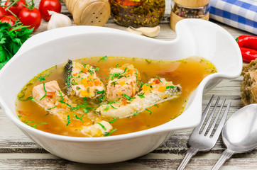 Fish soup. Fish soup with salmon on rustic wooden background. Healthy food 
