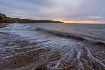 Filey seascape with wave trails, slow shutter to show the waves movement.