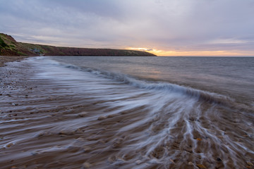 Obraz premium Filey seascape with wave trails, slow shutter to show the waves movement.