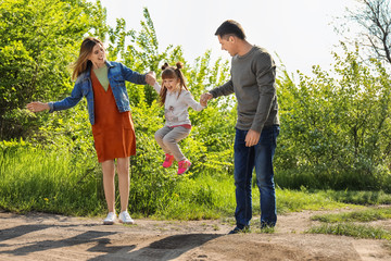 Obraz premium Happy family in park on sunny day