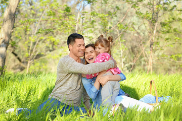 Fototapeta premium Happy family resting in park